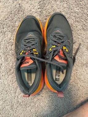 Hoka One One women’s Black Running Sneakers with Orange & Yellow Accents